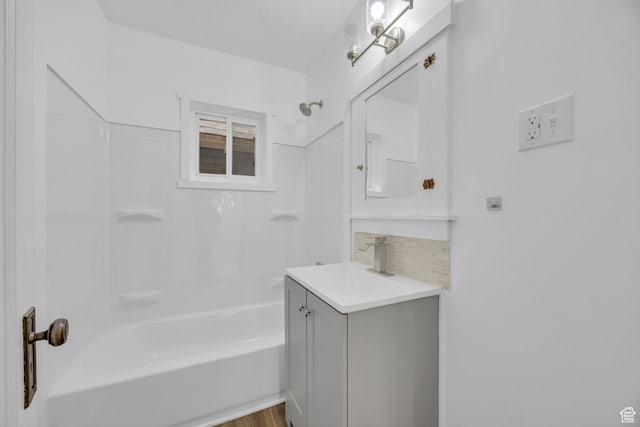 bathroom featuring vanity, wood-type flooring, backsplash, and shower / bathtub combination