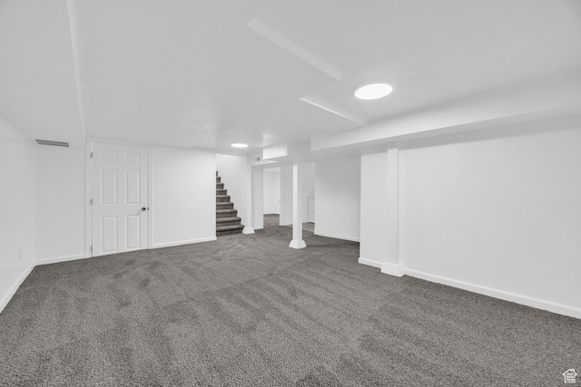 basement featuring dark colored carpet