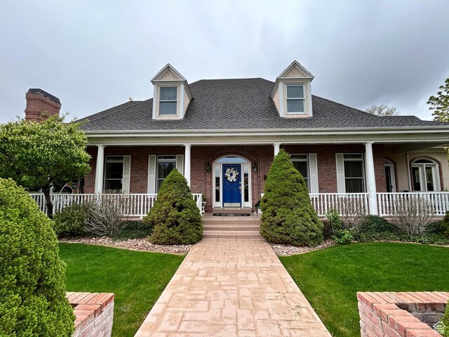 301 S Rachel Ln, New Harmony, UT 84757 - view of front of property featuring covered porch, brick siding, and a front yard
