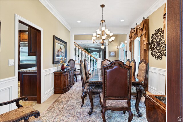 301 S Rachel Ln, New Harmony, UT 84757 - dining space featuring a chandelier, a decorative wall, crown molding, light wood-style flooring, and a wainscoted wall