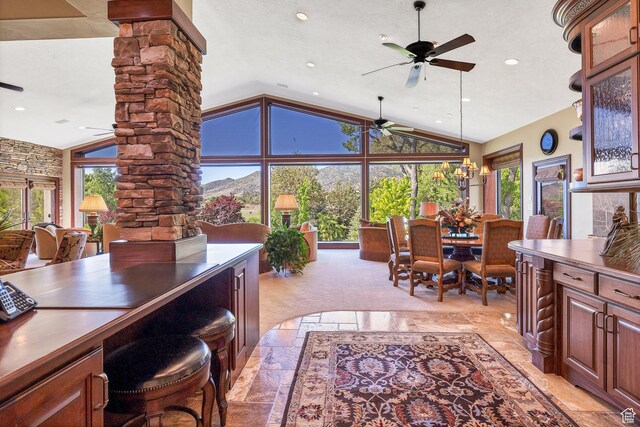 301 S Rachel Ln, New Harmony, UT 84757 - dining space with decorative columns, a ceiling fan, recessed lighting, stone tile floors, and high vaulted ceiling