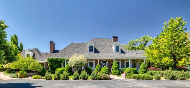 301 S Rachel Ln, New Harmony, UT 84757 - cape cod home featuring a porch and a chimney