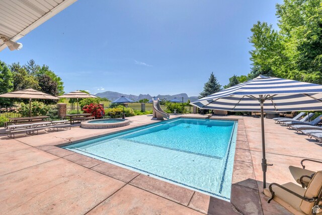 301 S Rachel Ln, New Harmony, UT 84757 - view of pool with a water slide, an in-ground hot tub, a patio, and a mountain view