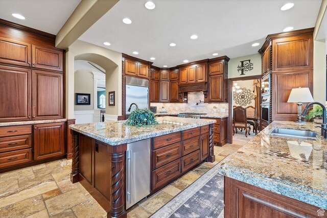 301 S Rachel Ln, New Harmony, UT 84757 - kitchen featuring a sink, arched walkways, stainless steel appliances, recessed lighting, and stone tile flooring