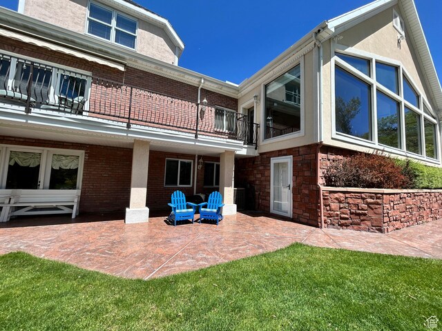 301 S Rachel Ln, New Harmony, UT 84757 - rear view of property featuring a balcony, a patio, stucco siding, and brick siding