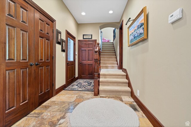 301 S Rachel Ln, New Harmony, UT 84757 - foyer entrance featuring baseboards, stairway, stone tile floors, arched walkways, and recessed lighting