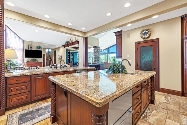 301 S Rachel Ln, New Harmony, UT 84757 - kitchen featuring a sink, recessed lighting, a kitchen island, light stone counters, and stone tile floors