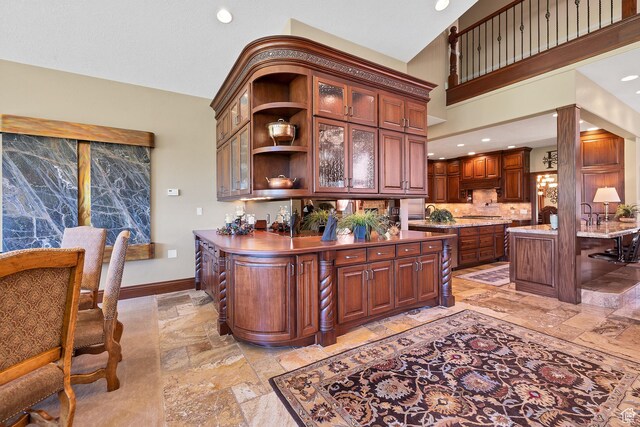 301 S Rachel Ln, New Harmony, UT 84757 - bar featuring stone tile floors, recessed lighting, tasteful backsplash, baseboards, and under cabinet range hood