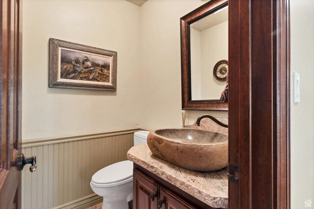 301 S Rachel Ln, New Harmony, UT 84757 - half bath with a wainscoted wall, toilet, and vanity