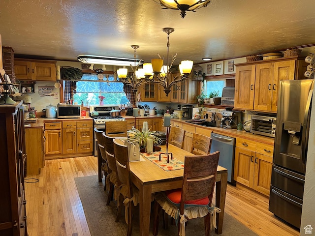 295 N 200 W, Monroe, UT 84754 - kitchen with appliances with stainless steel finishes, brown cabinets, and light wood-style flooring