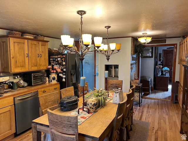 295 N 200 W, Monroe, UT 84754 - dining room featuring a chandelier, light wood-type flooring, and a toaster