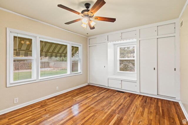 455 N 500 W, Richfield, UT 84701 - unfurnished bedroom featuring multiple closets, multiple windows, wood finished floors, crown molding, and baseboards