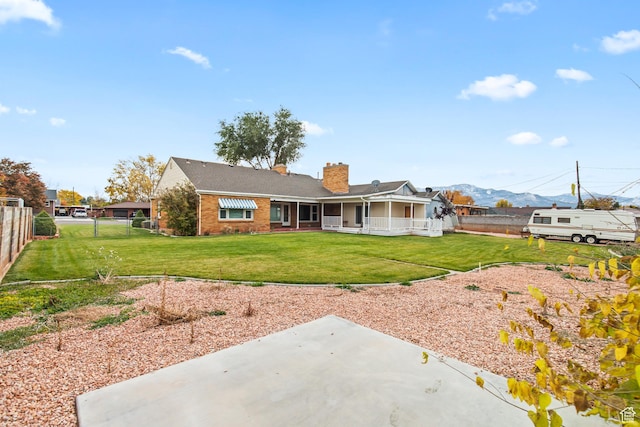455 N 500 W, Richfield, UT 84701 - rear view of house with a chimney, brick siding, a patio area, and a mountain view