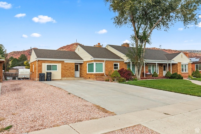 455 N 500 W, Richfield, UT 84701 - single story home featuring brick siding, concrete driveway, a chimney, a shingled roof, and covered porch