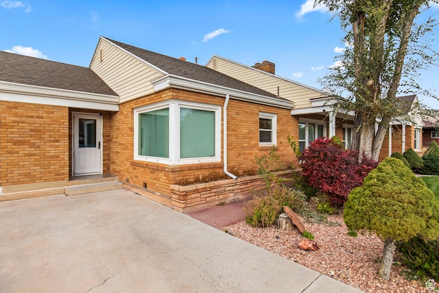 455 N 500 W, Richfield, UT 84701 - doorway to property featuring brick siding, a chimney, and a shingled roof