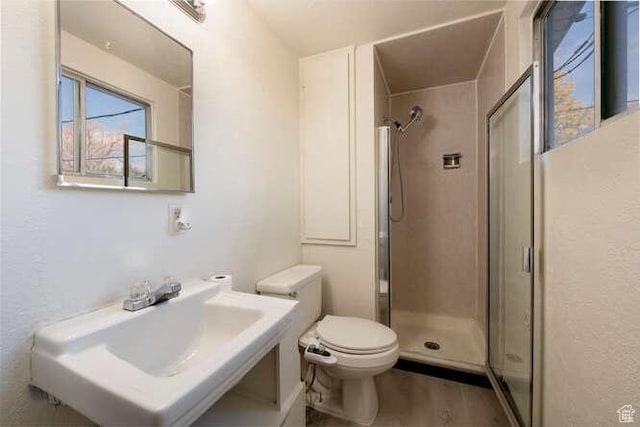 4143 S 2200th St W, Taylorsville, UT 84129 - bathroom featuring a stall shower, toilet, a sink, and wood finished floors