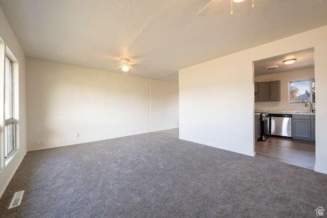 4143 S 2200th St W, Taylorsville, UT 84129 - empty room with ceiling fan, dark colored carpet, and a sink