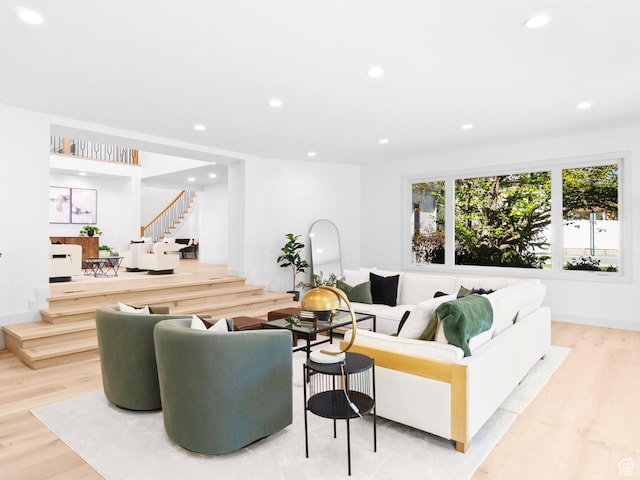 living room featuring stairs, recessed lighting, and light wood-style floors