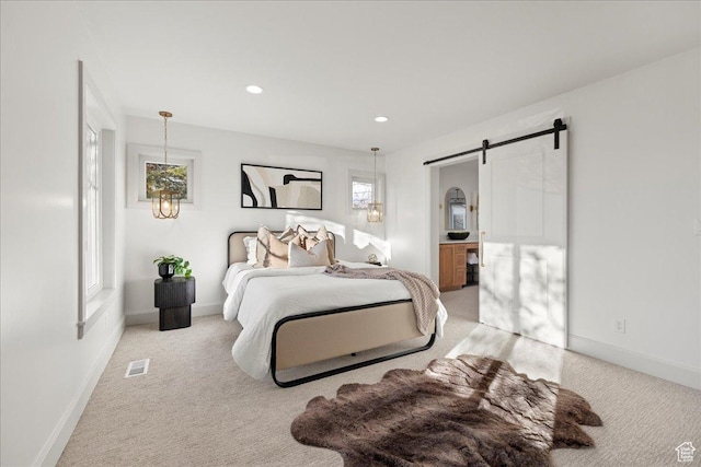 bedroom with light colored carpet, a barn door, recessed lighting, and baseboards