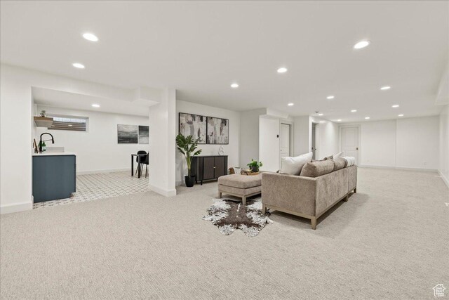 living area with light colored carpet, recessed lighting, and baseboards