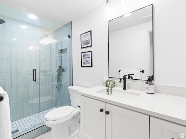 bathroom featuring toilet, a shower stall, vanity, and tile patterned flooring