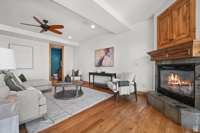 3025 Lower Saddleback Rd Unit 13, Park City, UT 84098 - living room featuring a tiled fireplace, ceiling fan, and light hardwood / wood-style floors