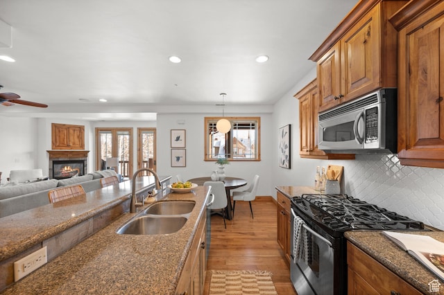 3025 Lower Saddleback Rd Unit 13, Park City, UT 84098 - kitchen with hanging light fixtures, appliances with stainless steel finishes, sink, and dark stone counters