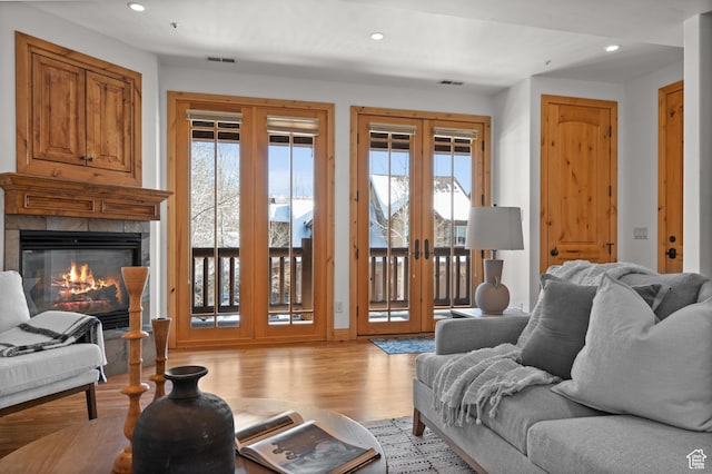 3025 Lower Saddleback Rd Unit 13, Park City, UT 84098 - living room with a tile fireplace, light wood-type flooring, and french doors