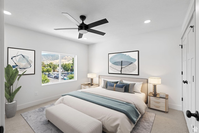 bedroom with light colored carpet, baseboards, recessed lighting, a closet, and ceiling fan