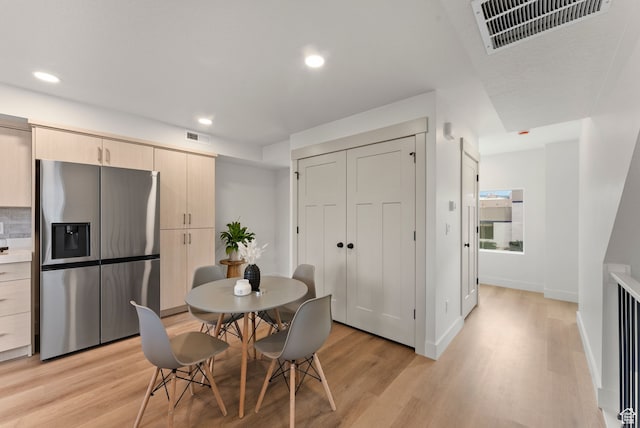 dining area with light wood-style floors, recessed lighting, and baseboards