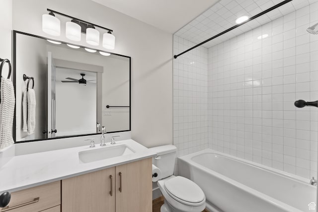 bathroom with a ceiling fan, toilet, vanity, and shower / bath combination