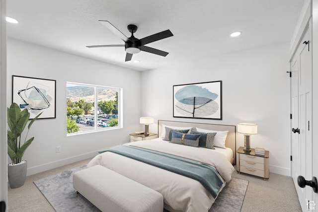 bedroom with light colored carpet, baseboards, recessed lighting, a closet, and a ceiling fan