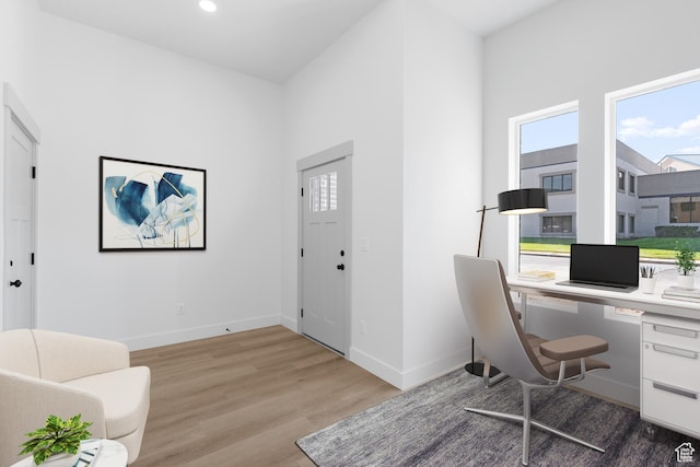 office featuring wood finished floors, baseboards, and recessed lighting