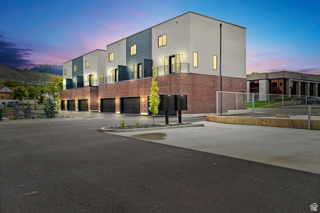 view of building exterior featuring a garage and concrete driveway
