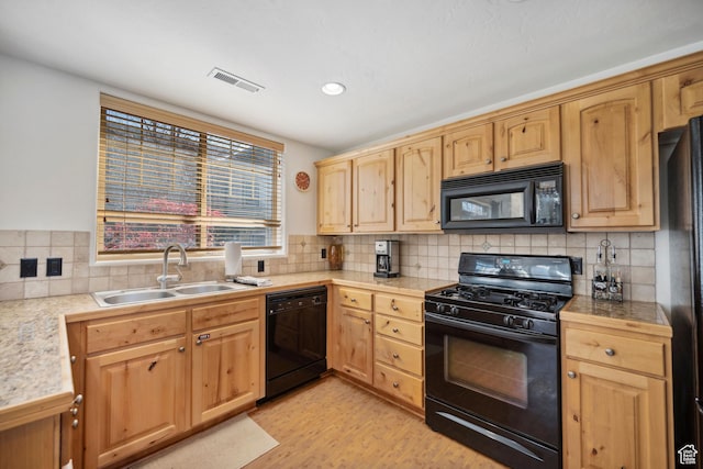 6042 N Fox Pointe Cir, Park City, UT 84098 - kitchen with black appliances, a sink, light brown cabinets, light wood finished floors, and backsplash