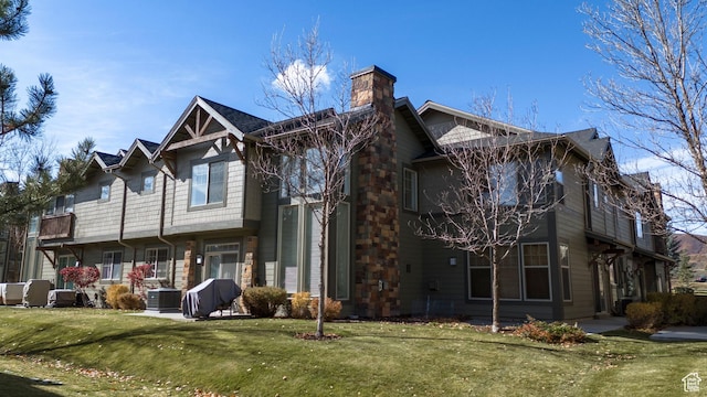 6042 N Fox Pointe Cir, Park City, UT 84098 - rear view of property with cooling unit, a chimney, and a lawn