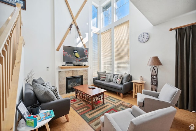 6042 N Fox Pointe Cir, Park City, UT 84098 - living area featuring a high ceiling, a fireplace, and wood finished floors