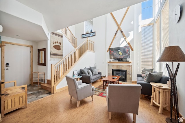 6042 N Fox Pointe Cir, Park City, UT 84098 - living room featuring wood finished floors, stairway, a fireplace, and a towering ceiling