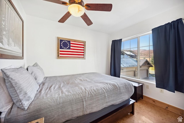 6042 N Fox Pointe Cir, Park City, UT 84098 - bedroom featuring wood finished floors, a ceiling fan, and a mountain view
