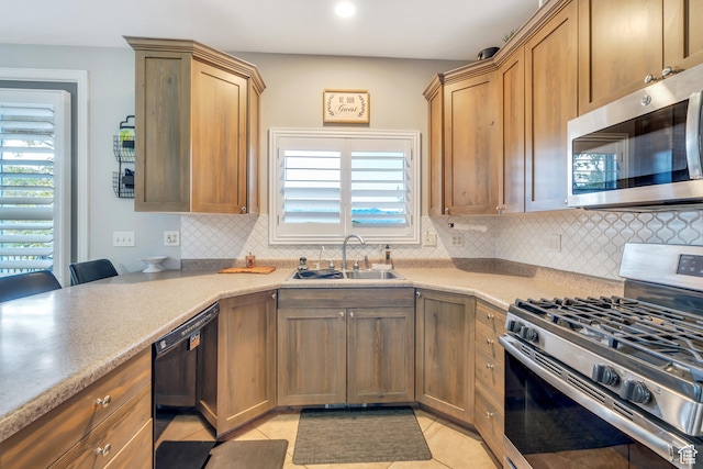 1122 Ironwood Rd, Erda, UT 84074 - kitchen with plenty of natural light, backsplash, sink, and stainless steel appliances