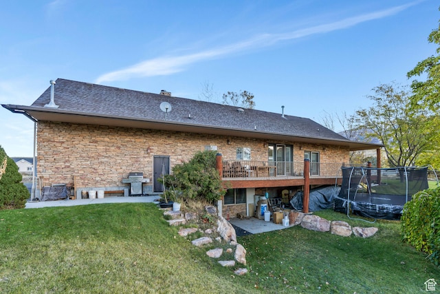 1122 Ironwood Rd, Erda, UT 84074 - back of house with a patio area, a lawn, a wooden deck, and a trampoline