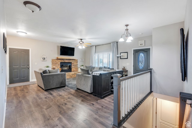 1122 Ironwood Rd, Erda, UT 84074 - living room with ceiling fan with notable chandelier, hardwood / wood-style flooring, and a fireplace