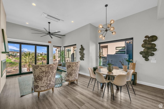 1498 W Torrey Pines Rd, Hurricane, UT 84737 - dining space featuring baseboards, wood finished floors, high vaulted ceiling, a chandelier, and recessed lighting