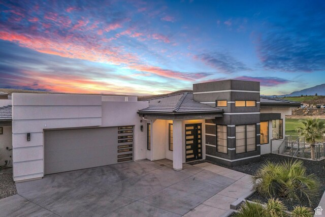 1498 W Torrey Pines Rd, Hurricane, UT 84737 - contemporary home featuring a garage, concrete driveway, and stucco siding