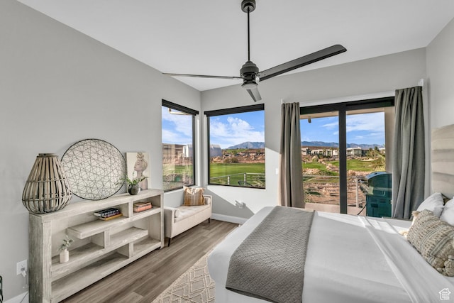 1498 W Torrey Pines Rd, Hurricane, UT 84737 - bedroom with wood finished floors, baseboards, a mountain view, and a ceiling fan
