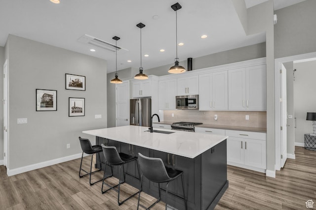 1498 W Torrey Pines Rd, Hurricane, UT 84737 - kitchen featuring appliances with stainless steel finishes, a sink, light wood finished floors, backsplash, and recessed lighting