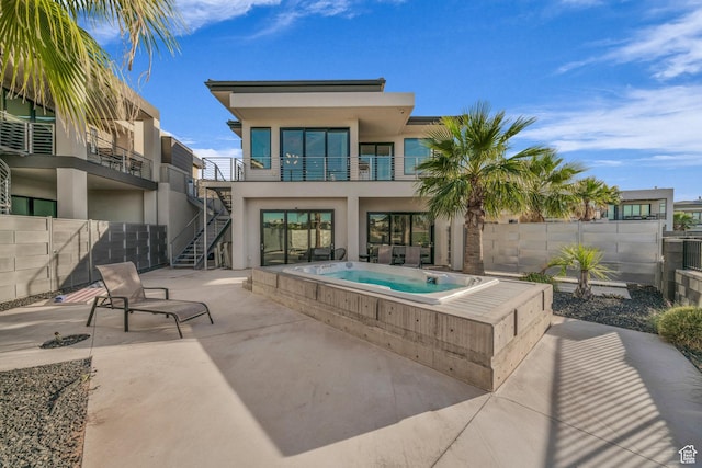 1498 W Torrey Pines Rd, Hurricane, UT 84737 - rear view of house with an in-ground hot tub, stucco siding, a patio, a fenced backyard, and stairway