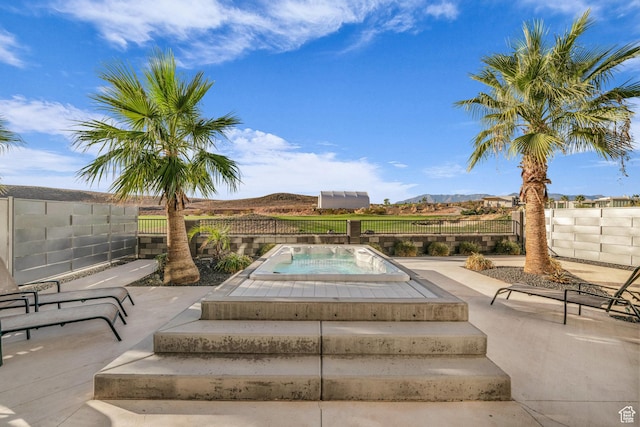 1498 W Torrey Pines Rd, Hurricane, UT 84737 - view of swimming pool with an in-ground hot tub, a fenced backyard, a mountain view, and a patio