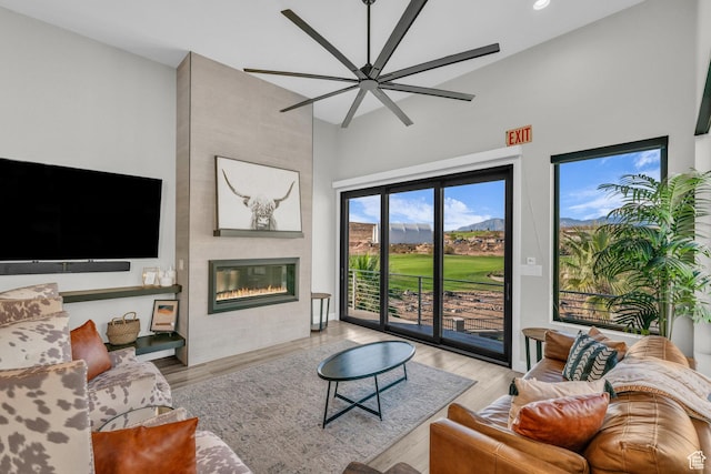 1498 W Torrey Pines Rd, Hurricane, UT 84737 - living area featuring high vaulted ceiling, a fireplace, light wood finished floors, a ceiling fan, and recessed lighting