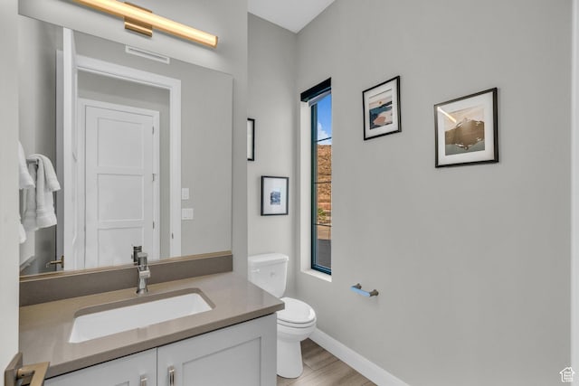 1498 W Torrey Pines Rd, Hurricane, UT 84737 - bathroom with toilet, baseboards, vanity, and wood finished floors